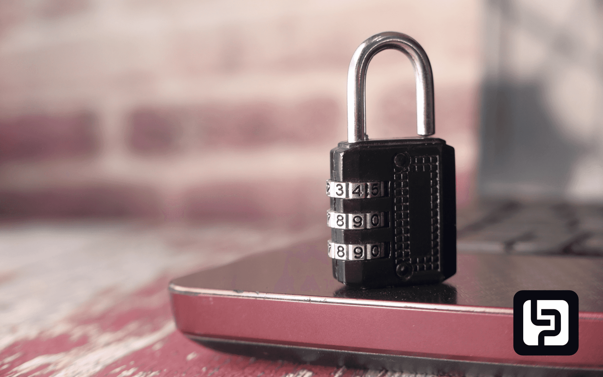 Combination padlock on a laptop keyboard